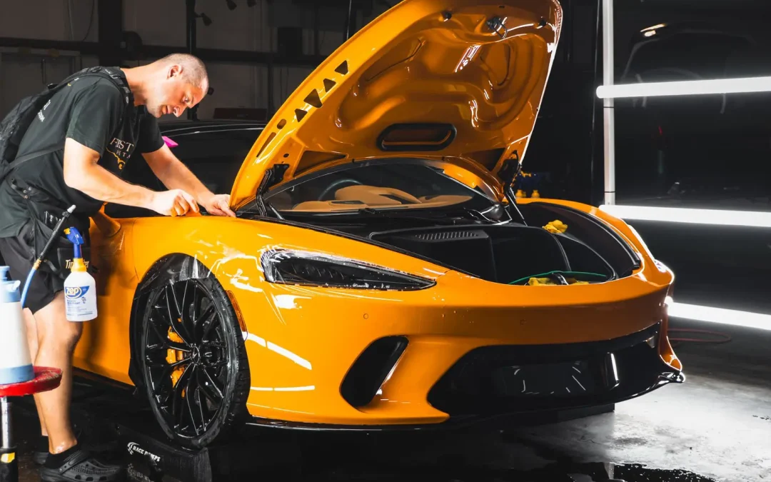 man professionally detailing a McLaren in Tampa Bay